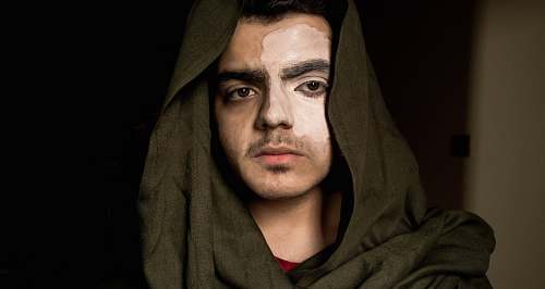 person man in black hoodie on focus photography face