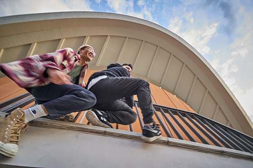 person two men hanging on railings architecture