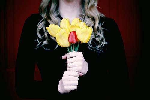 person woman holding artificial flowers people