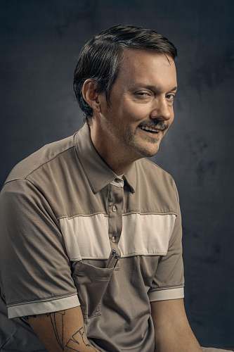 person man wearing white and gray polo shirt human