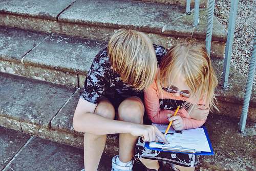 human boy and girl answering questions on white paper people