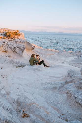human man and woman on seashore greece