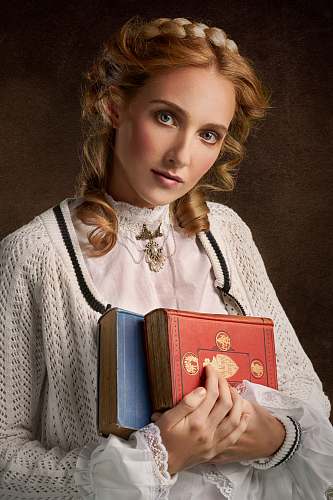apparel woman holding two books clothing