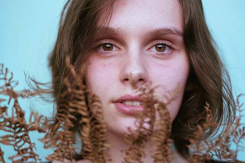 person woman holding brown plants people