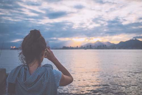person woman standing near body of water during daytime people