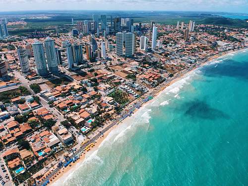 scenery aerial photography of city building near the seashore during daytime outdoors
