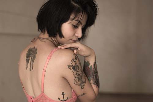woman standing woman wearing pink bra with tattoos tattoo