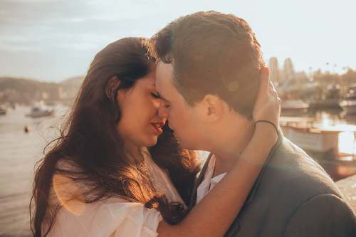 kiss man and woman kissing beside bay couple