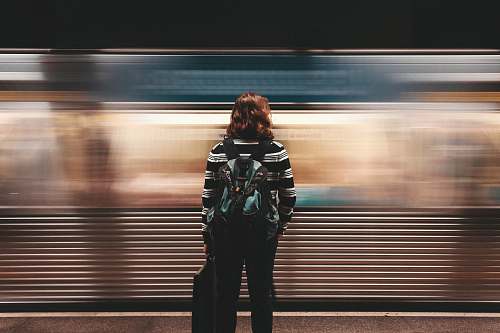 people person standing in front of train station motion