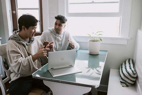 person man in white dress shirt using silver macbook human