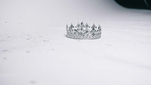 tiara silver-colored crown ring on white surface ornament