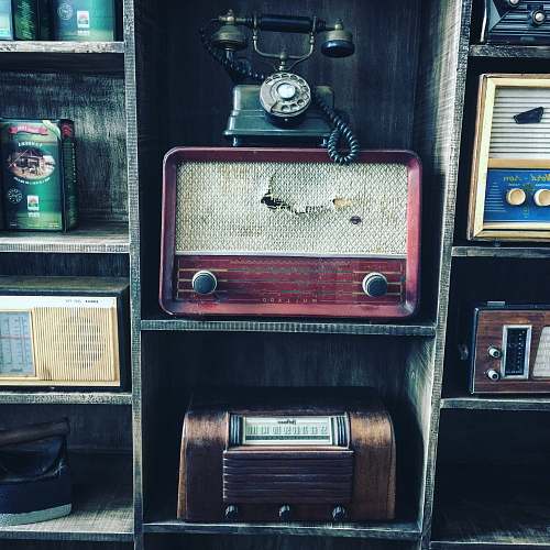 vintage black rotary telephone on red transistor radio phone