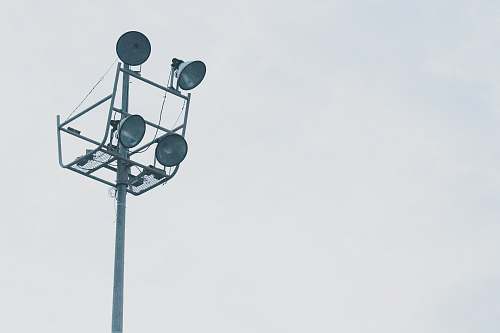 light gray megaphones on gray metal post grey