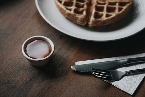 food waffle on plate beside dip, fork, and knife são paulo