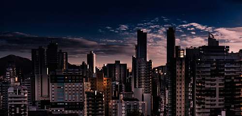 town city building photo across clouds urban