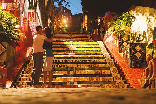 vase man and woman kissing in front of stairs pottery