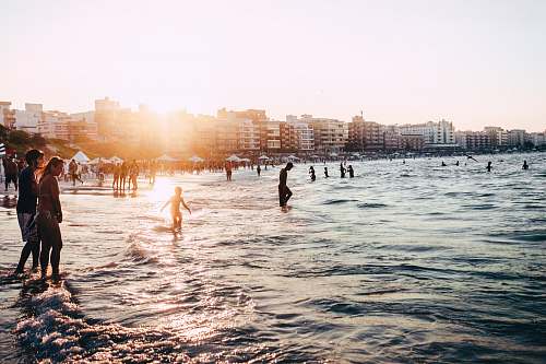 person people standing near body of water at daytime people