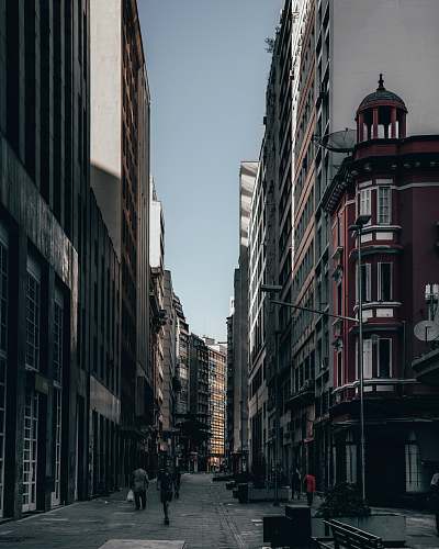 person person walking between buildings path