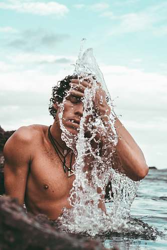person topless man bathing on seashore brazil