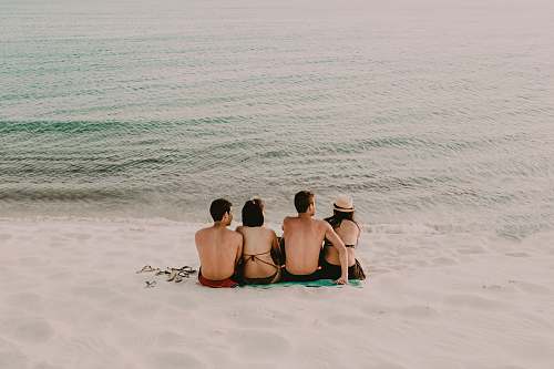 person two men and women sitting on shore back