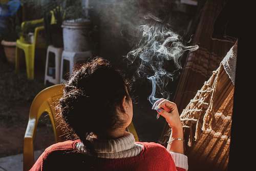 person woman holding cigarette people