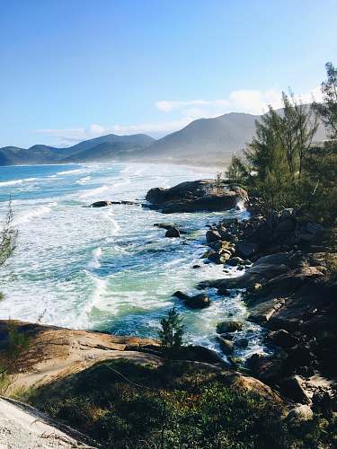 ocean photo of seashore and mountain scenery promontory