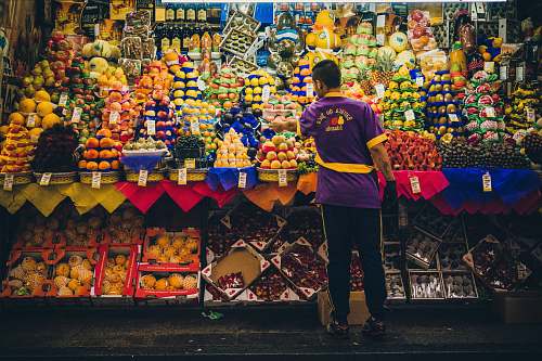 person man standing in front of produce stand human