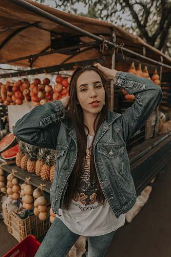 person woman standing in front of fruit stand selective focus photography human