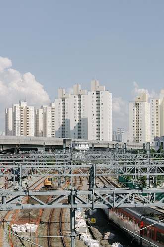 train city buildings during daytime vehicle