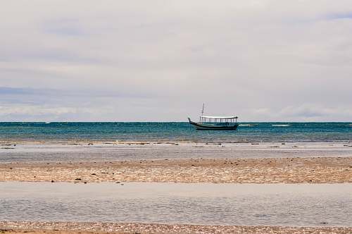 transportation white and black boat on sea under white and blue skies boat