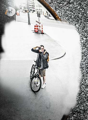 bike man standing beside bicycle during daytime transportation