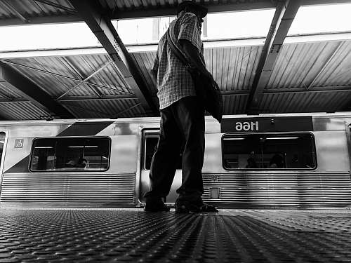 banister man standing on the train station handrail