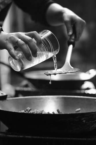 person person pouring water on wok human