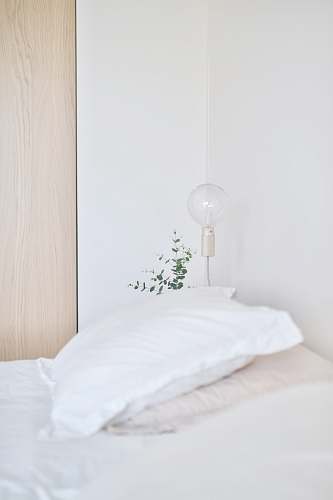 pillow white bed pillow near table lamp cushion