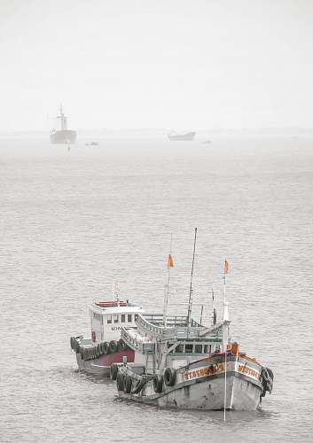 vehicle white and green ship on sea during daytime vessel