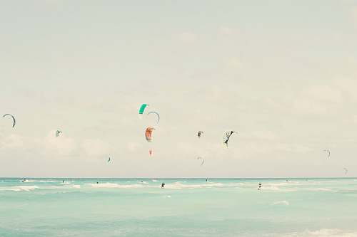kite many people parachuting during daytime grey
