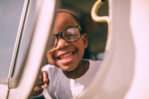 boy taking picture on window