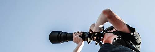 person person holding black DSLR camera people