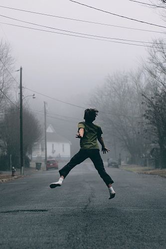 Kid jumps in the middle of the road on a foggy day