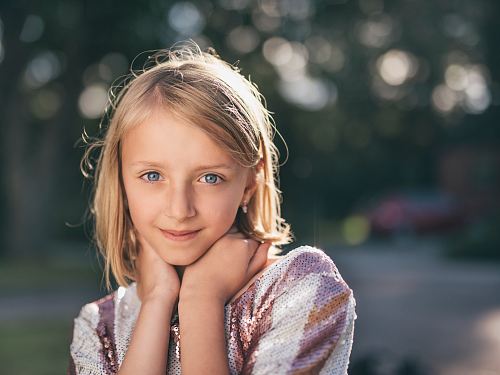 selective focus photography of girl in sequined white-and-pink stripe shirt
