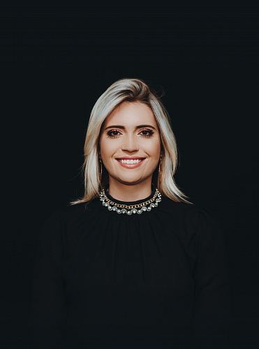 smiling woman wearing black crew-neck top
