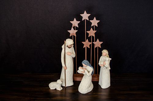 three religious figurines on brown surface