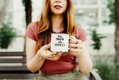 woman holding mug during daytime