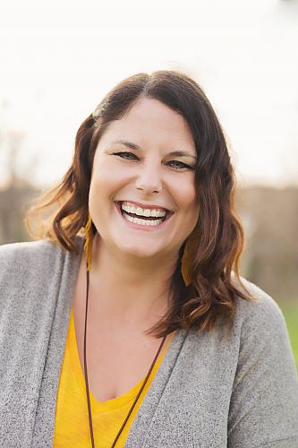woman in gray cardigan smiling