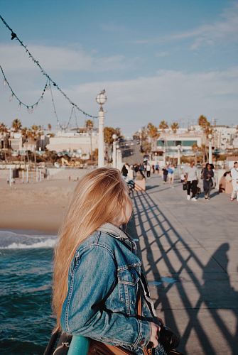woman leaning on metal fence