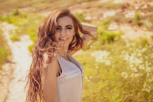 woman standing near grass field during daytime
