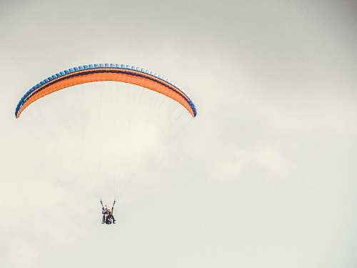 gliding orange and blue parachute leisure activities