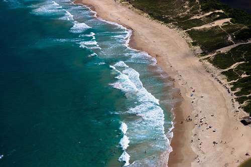 coast aerial photo of people at seashore nature