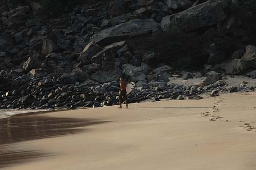 prainha person standing near rock formations rock
