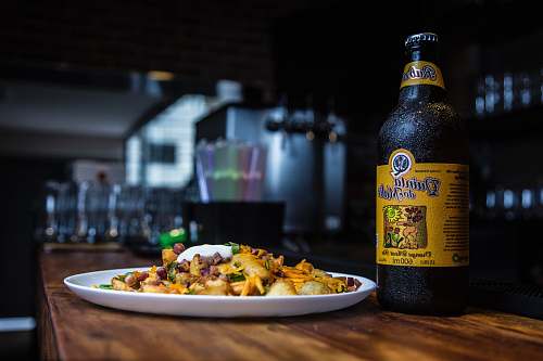 beer Quinta bottle beside cook food on brown wooden table são paulo